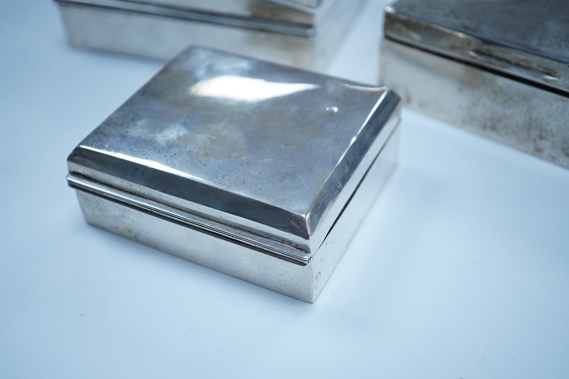 Three assorted George V/George VI silver mounted cigarette boxes, including two with engine tuned covers, the largest by Joseph Gloster Ltd, Birmingham, 1946, 12.8cm.
